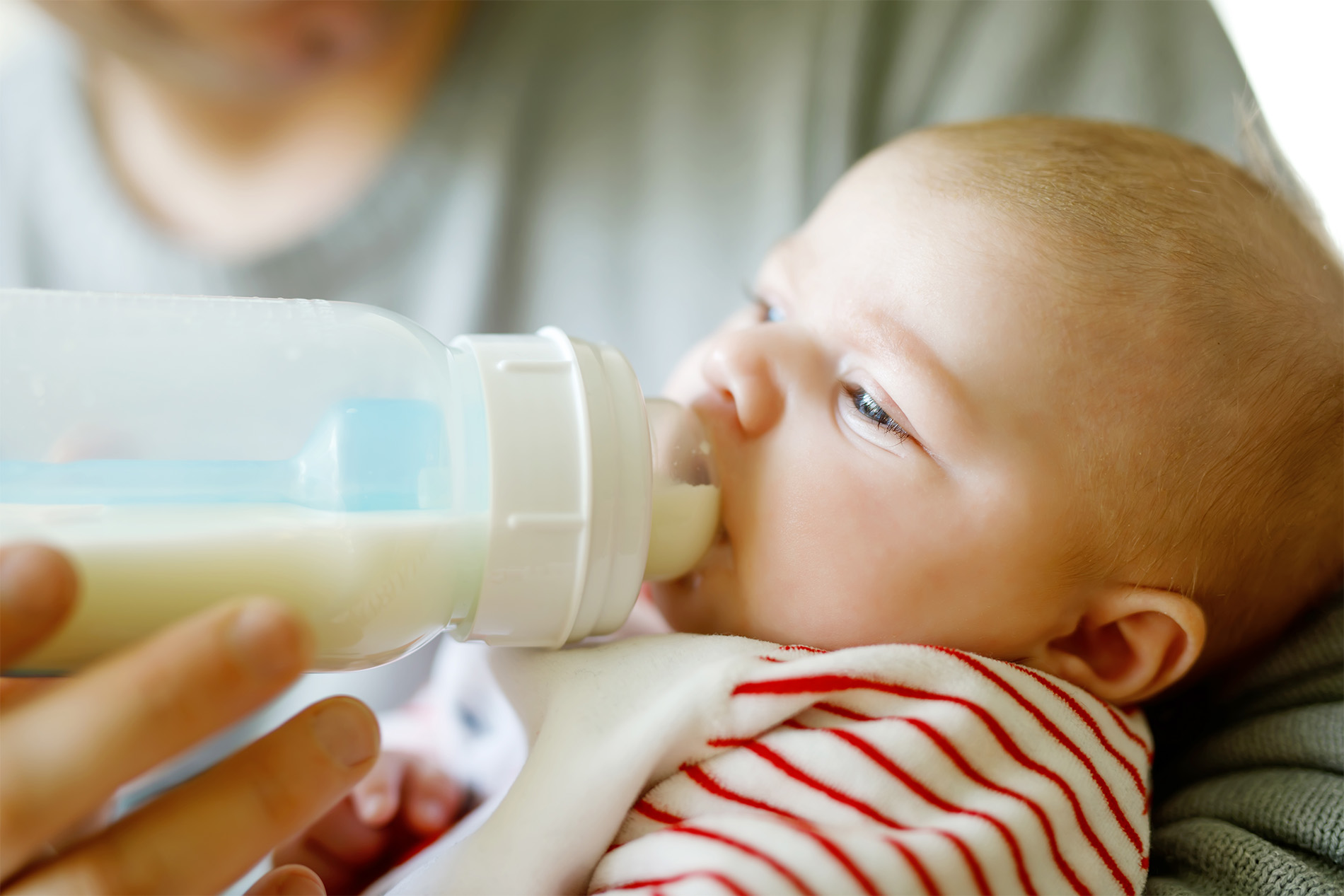 Dad bottle feeding baby